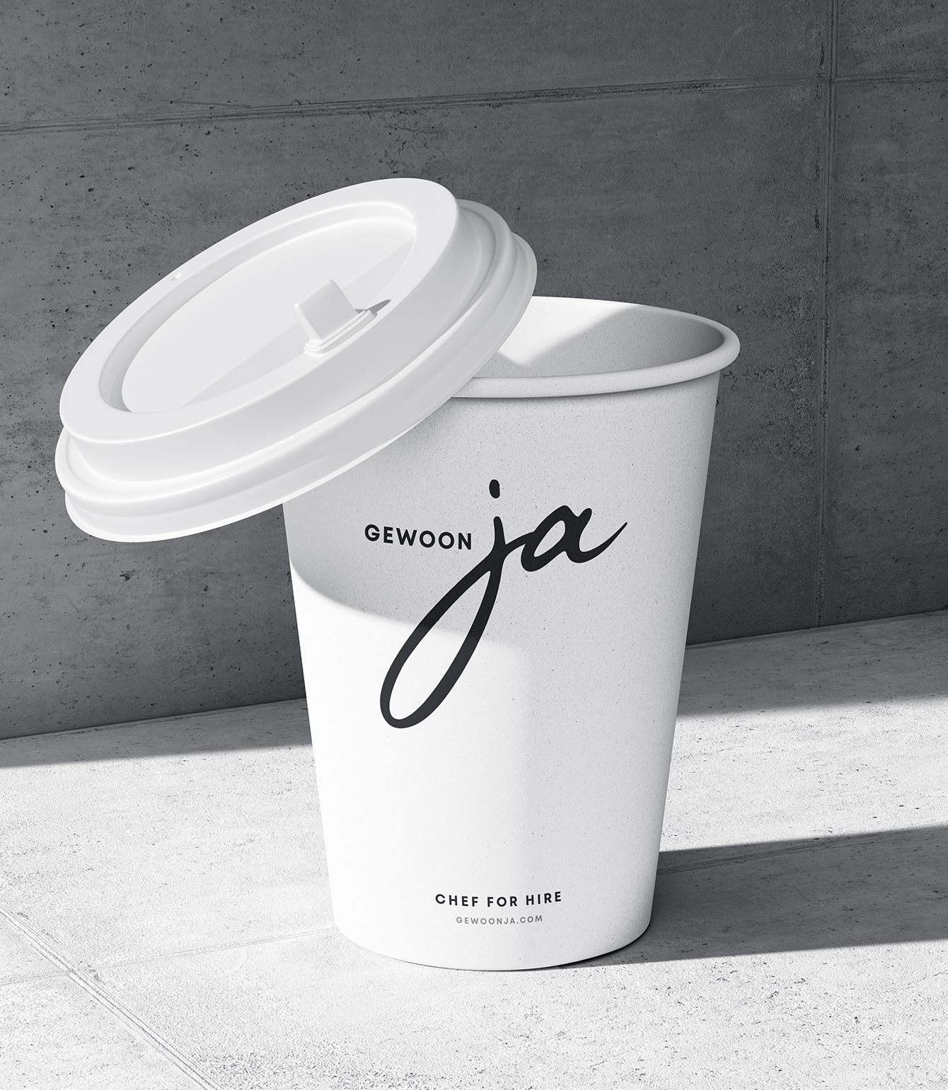 white cup with a minimalistic logo printed on a concrete background